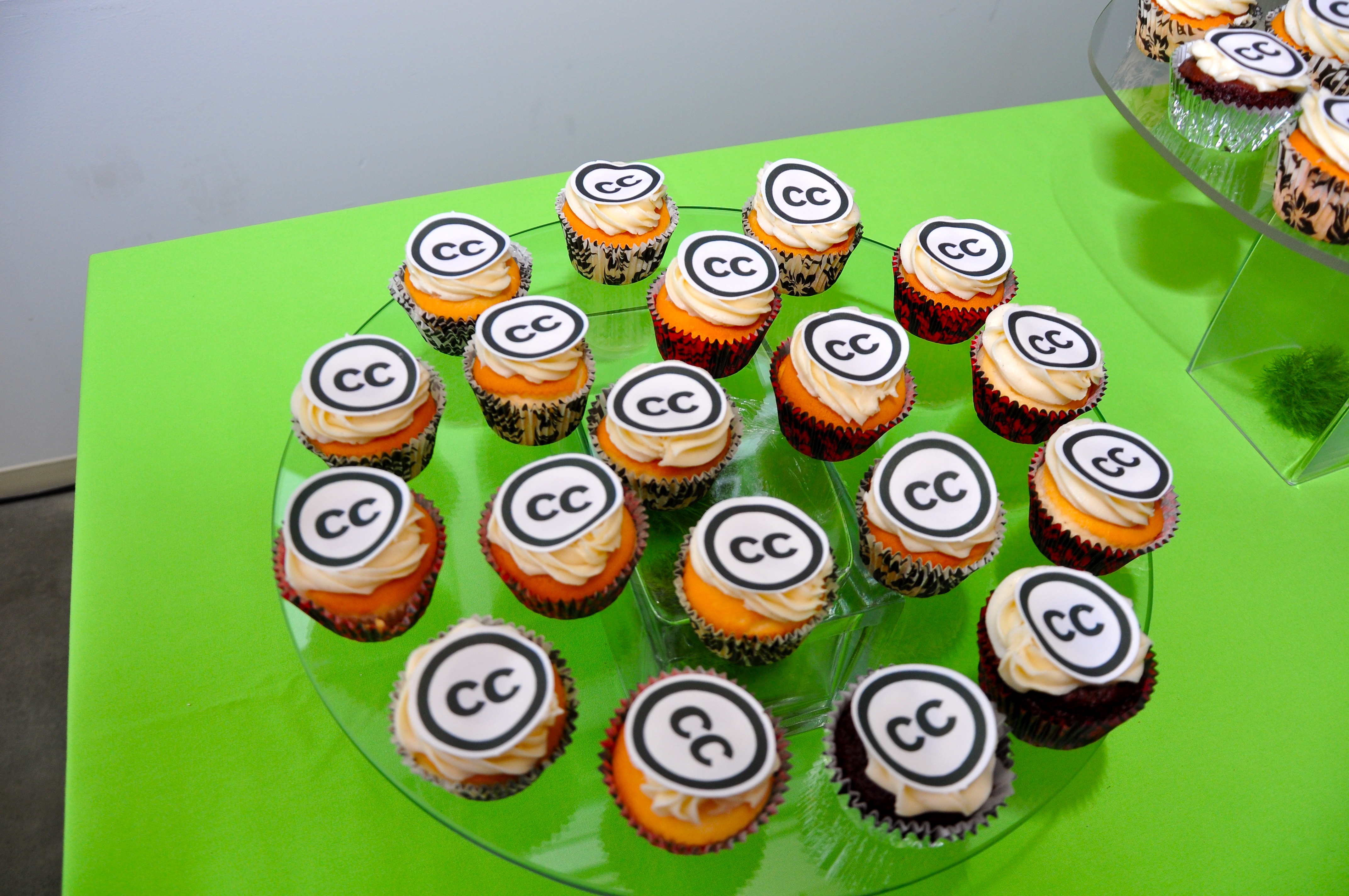 A photo from Creative Commons 10th Birthday Celebration San Francisco, a plate with cupcakes with a "CC" sign (acronym of the company name) on top.